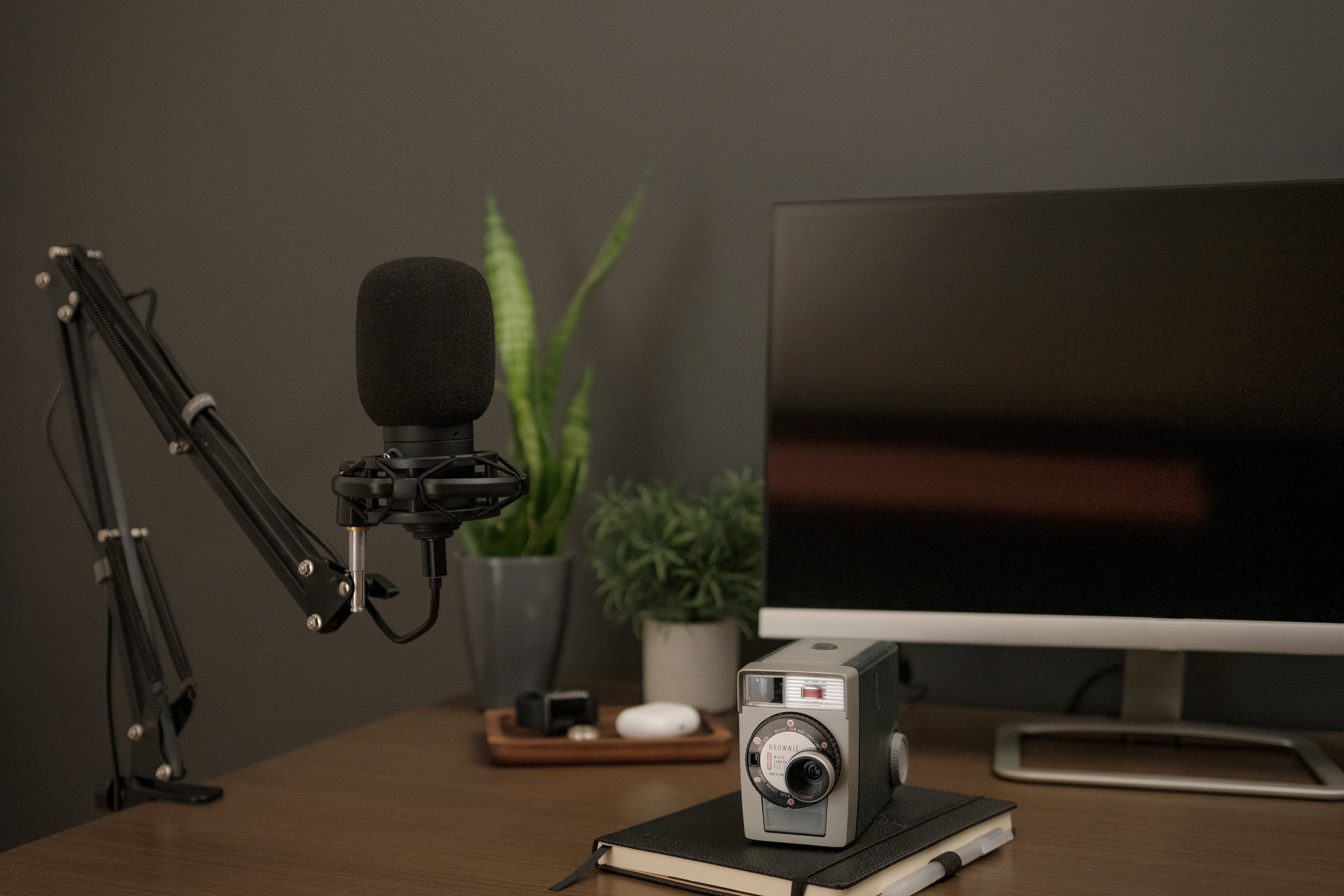 a-black-microphone-accompanied-by-a-notebook-and-vintage-camera.jpg