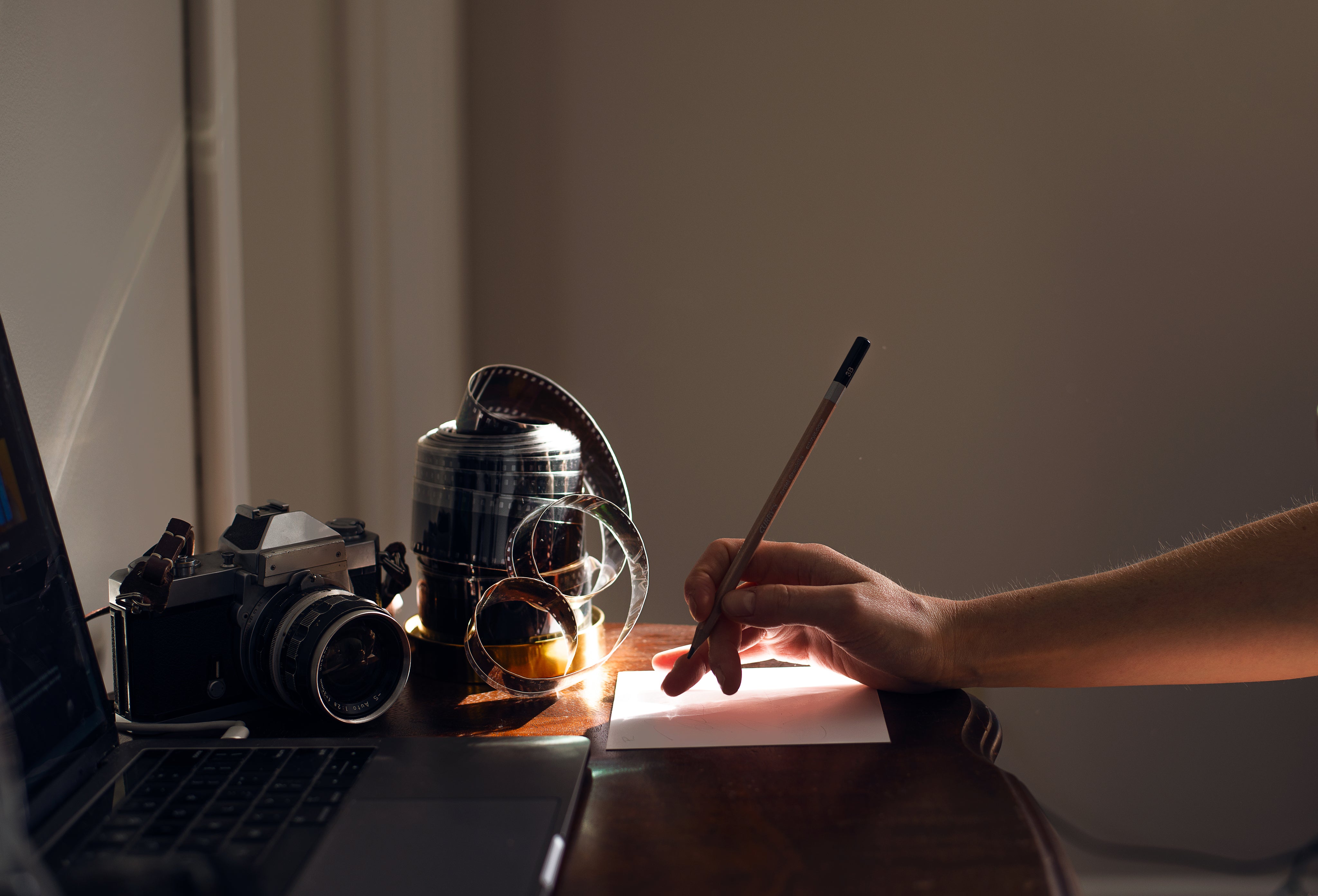 hand-holds-a-pencil-ready-to-write-at-a-desk.jpg